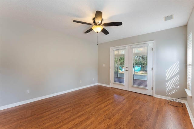 unfurnished room with hardwood / wood-style flooring, ceiling fan, french doors, and a textured ceiling