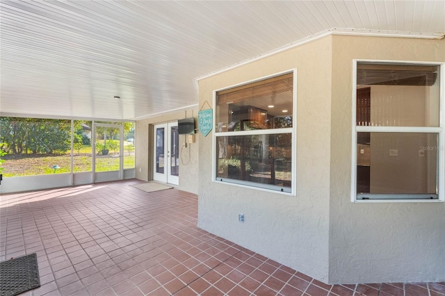 unfurnished sunroom featuring french doors