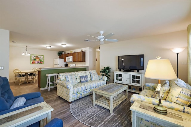 living room with dark wood-type flooring and ceiling fan