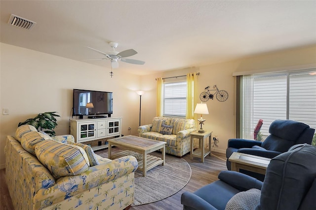 living room featuring hardwood / wood-style flooring and ceiling fan