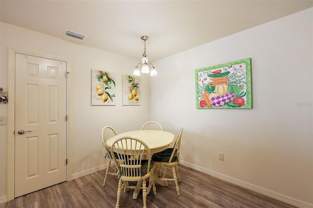 dining space featuring dark wood-type flooring