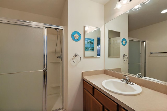 bathroom with vanity and a shower with shower door