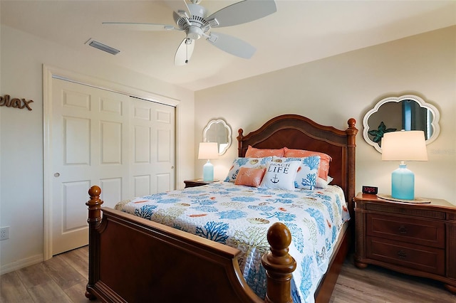 bedroom featuring light hardwood / wood-style flooring, a closet, and ceiling fan