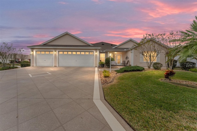 view of front facade with a garage and a yard