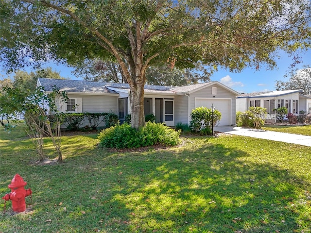 ranch-style house featuring a garage and a front lawn