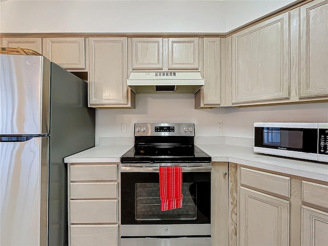 kitchen with appliances with stainless steel finishes and light brown cabinetry