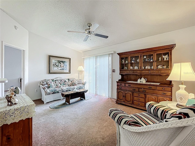 carpeted living room with lofted ceiling, ceiling fan, and a textured ceiling