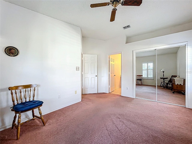 carpeted bedroom with ceiling fan and a closet