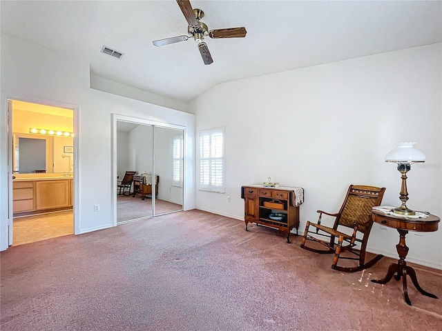 living area with vaulted ceiling, carpet flooring, and ceiling fan