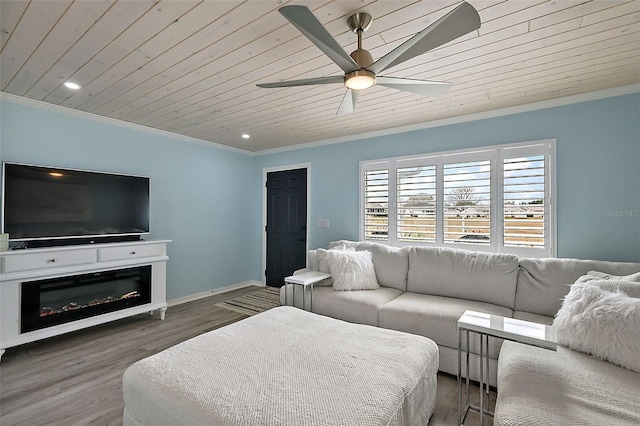 living room featuring wood ceiling, crown molding, hardwood / wood-style floors, and ceiling fan