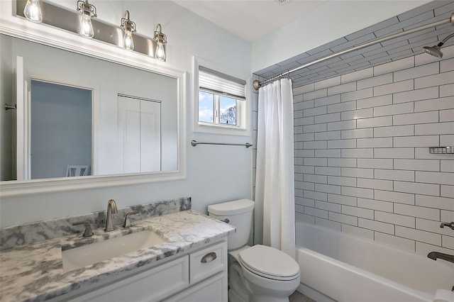 full bathroom featuring shower / tub combo with curtain, vanity, and toilet