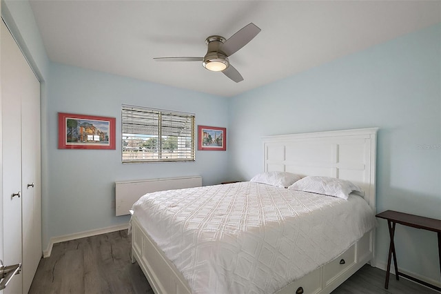 bedroom with dark hardwood / wood-style floors and ceiling fan