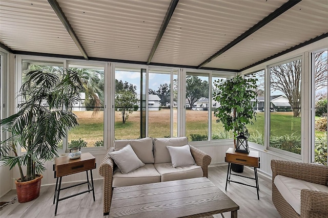 sunroom / solarium featuring beamed ceiling