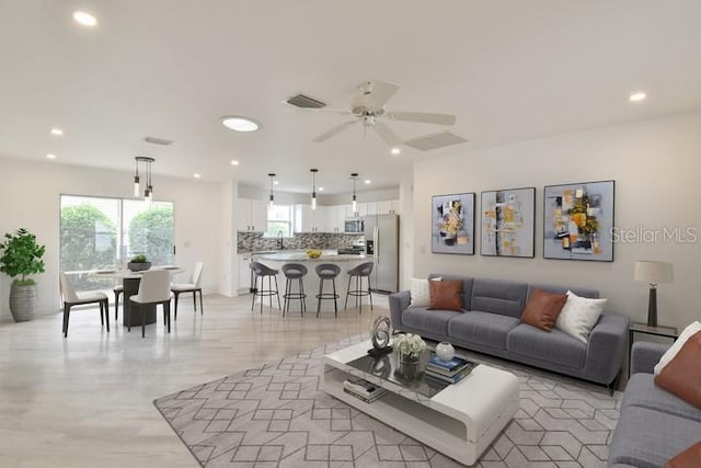 living room with ceiling fan and sink