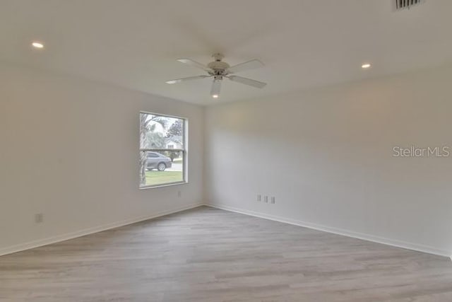 spare room with light hardwood / wood-style flooring and ceiling fan