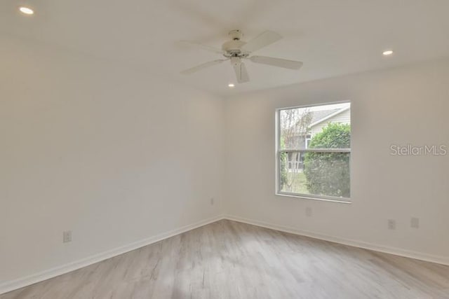 empty room featuring ceiling fan and light wood-type flooring