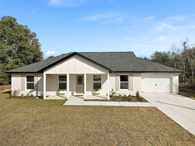 view of front of property with a garage, a front yard, and covered porch