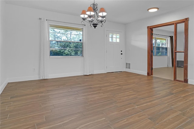 interior space featuring a chandelier and light wood-type flooring