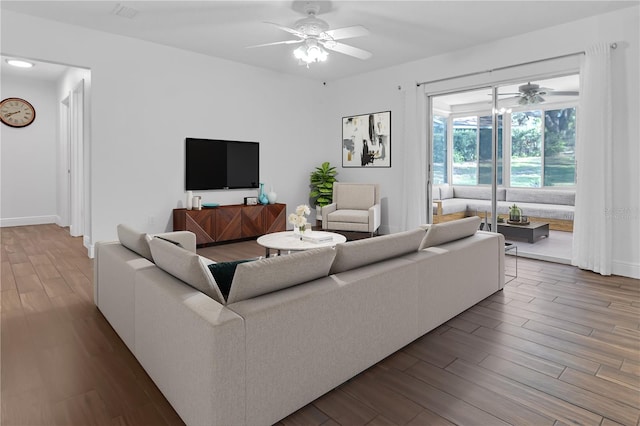 living room with ceiling fan and wood-type flooring