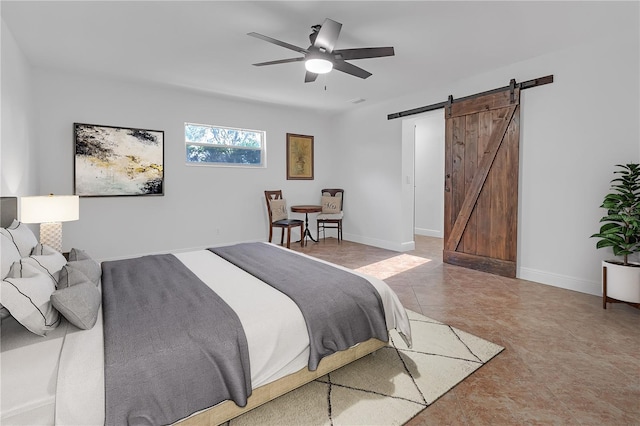 bedroom featuring a barn door and ceiling fan