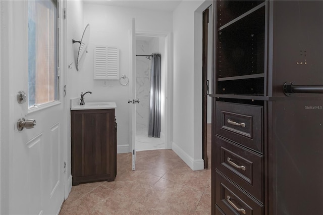 bathroom with vanity, tile patterned floors, and walk in shower