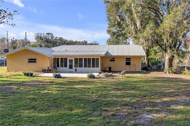 rear view of house with a yard and a patio area