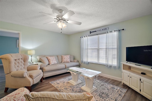 living room featuring dark hardwood / wood-style floors, a textured ceiling, and ceiling fan