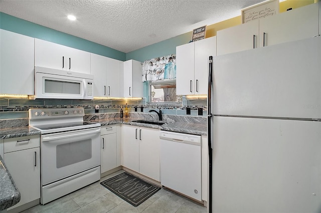 kitchen featuring white cabinetry, white appliances, sink, and tasteful backsplash