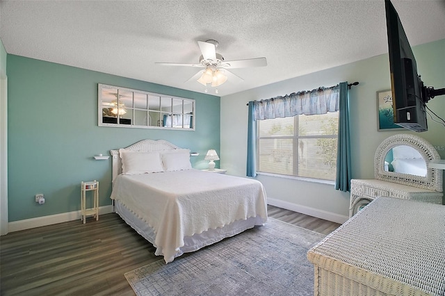 bedroom featuring ceiling fan, dark hardwood / wood-style floors, and a textured ceiling