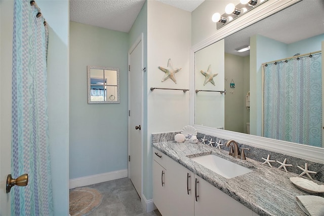 bathroom featuring vanity and a textured ceiling