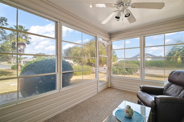 sunroom / solarium featuring a wealth of natural light and ceiling fan