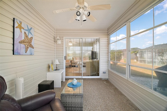 sunroom / solarium featuring ceiling fan