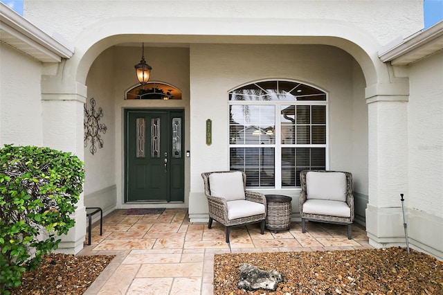 entrance to property featuring stucco siding