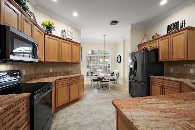 kitchen with black appliances, brown cabinetry, visible vents, hanging light fixtures, and crown molding