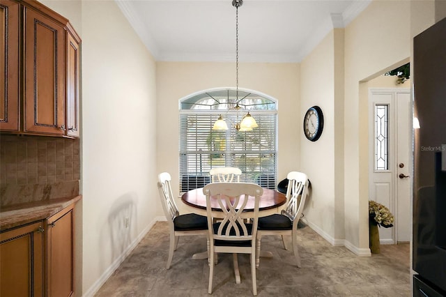 dining room with baseboards and ornamental molding