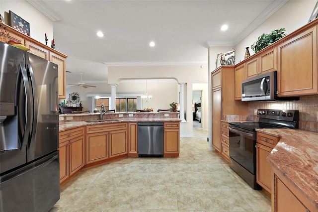 kitchen featuring brown cabinetry, a sink, decorative columns, and black appliances