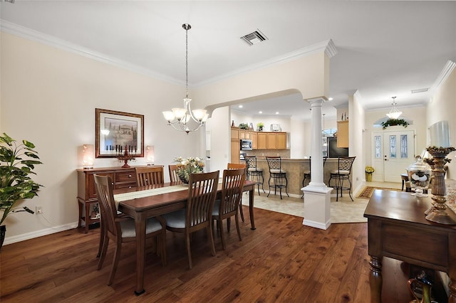 dining space with ornate columns, crown molding, dark wood-type flooring, and visible vents