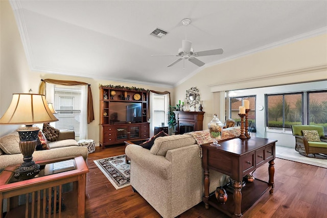 living room with crown molding, dark wood-style flooring, vaulted ceiling, and visible vents