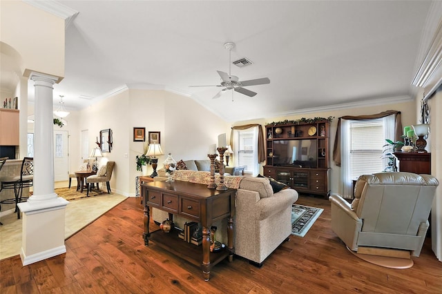 living area with ornate columns, dark wood finished floors, ceiling fan, and ornamental molding