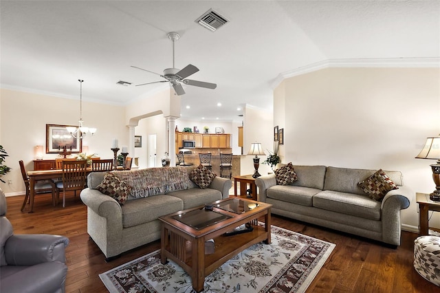 living area featuring crown molding, dark wood-style flooring, decorative columns, and visible vents