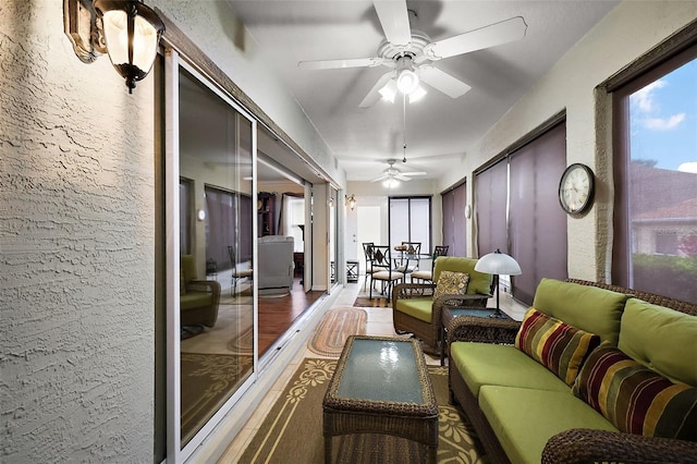 sunroom / solarium with a ceiling fan