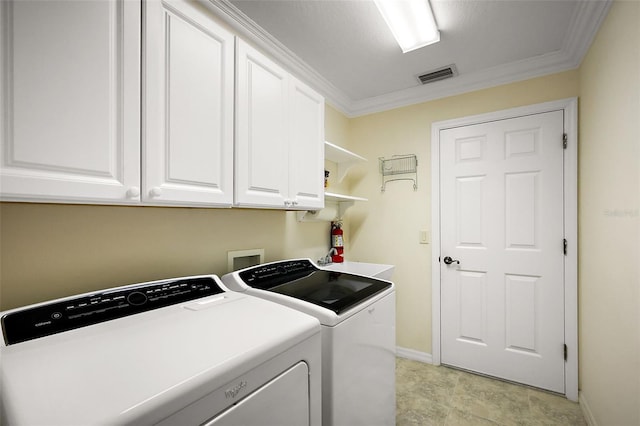 washroom with crown molding, cabinet space, washing machine and clothes dryer, baseboards, and visible vents