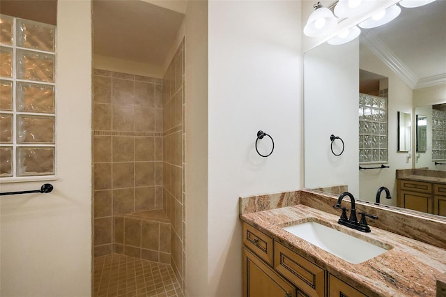 bathroom featuring ornamental molding, walk in shower, and vanity