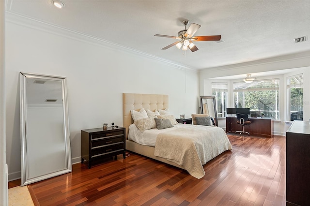 bedroom with crown molding, ceiling fan, and dark hardwood / wood-style flooring