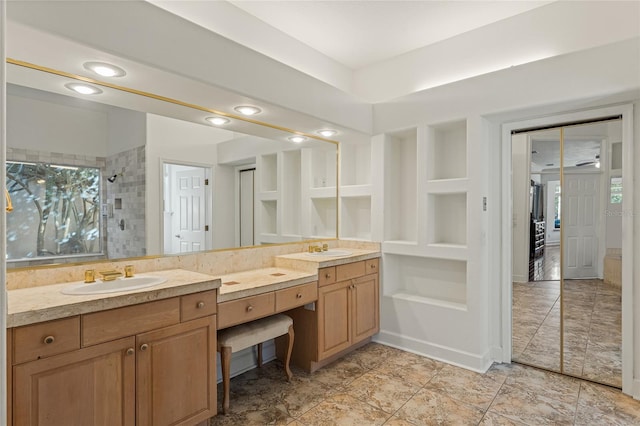 bathroom with vanity, built in features, and tiled shower