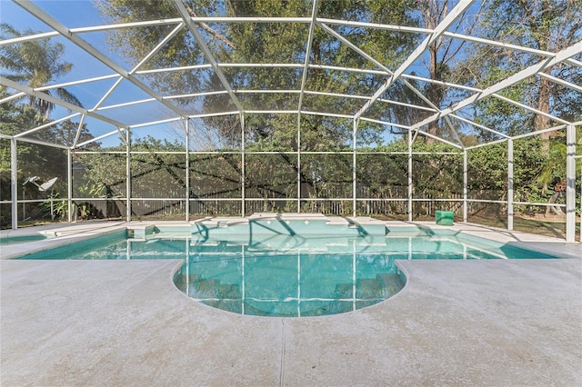 view of swimming pool featuring a patio and a lanai