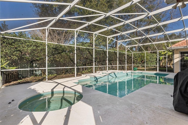 view of swimming pool featuring an in ground hot tub, a lanai, and a patio