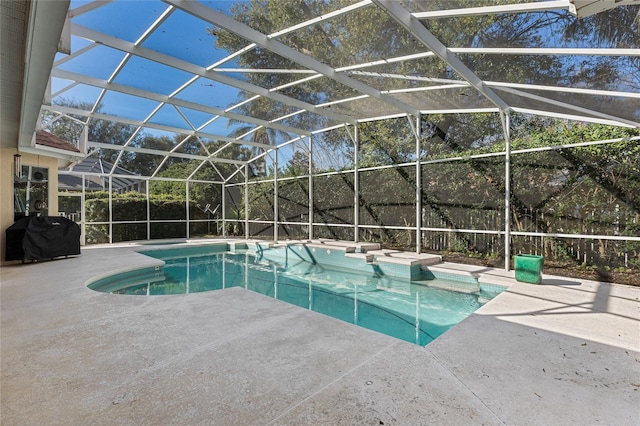 view of pool with a patio, area for grilling, and glass enclosure