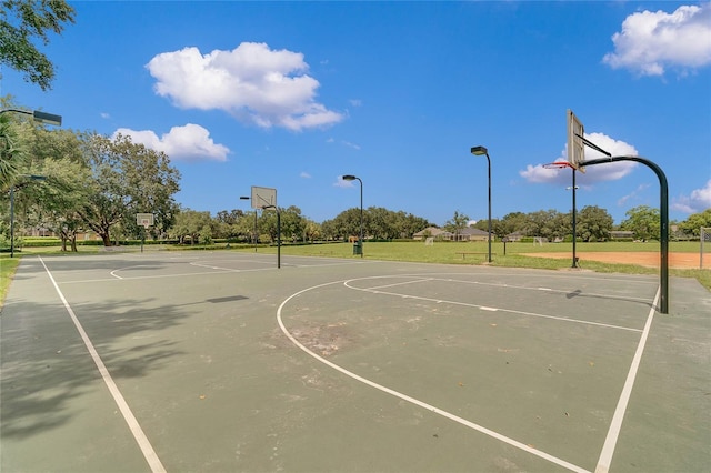 view of sport court featuring a yard