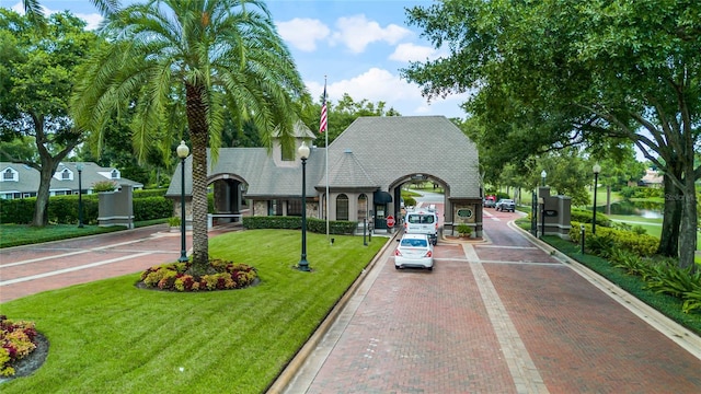 view of front facade featuring a front lawn and a water view